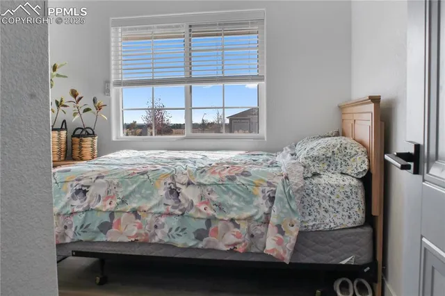 a bed sitting in a bedroom next to a window