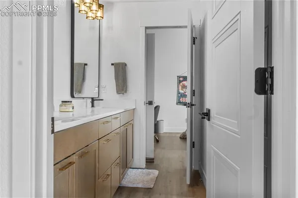 a bathroom with a shower sink and mirror