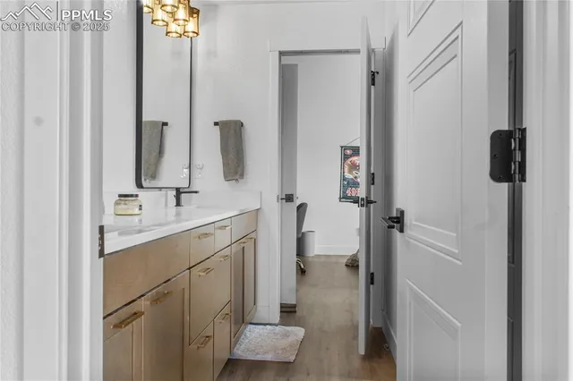 a bathroom with a shower sink and mirror