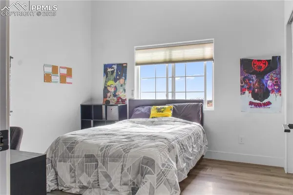 a bed sitting in a bedroom next to a window