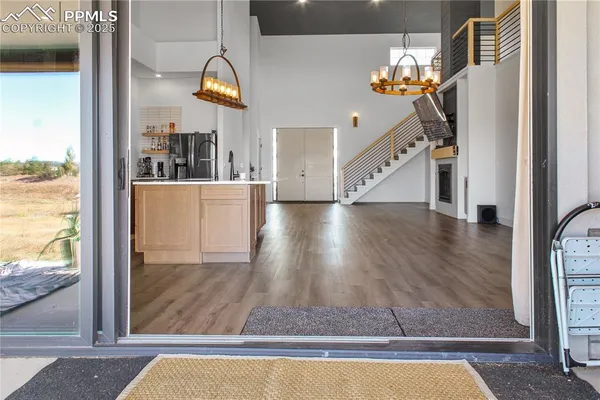 a view of entryway and hall with wooden floor
