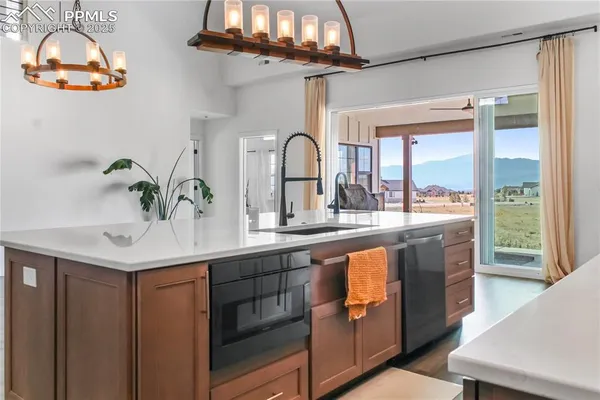 a kitchen with a sink and a large window