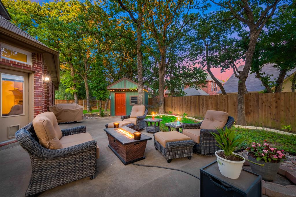 a view of a patio with couches plants and a fire pit