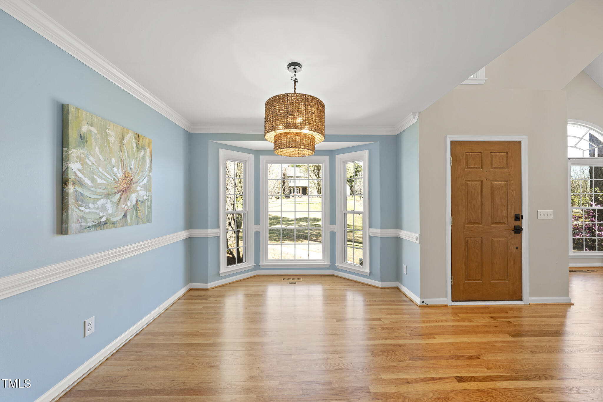 8063 Hogan Drive Wake Forest, NC 27587 - Photo 12 of 46 a view of an empty room with wooden floor and a window