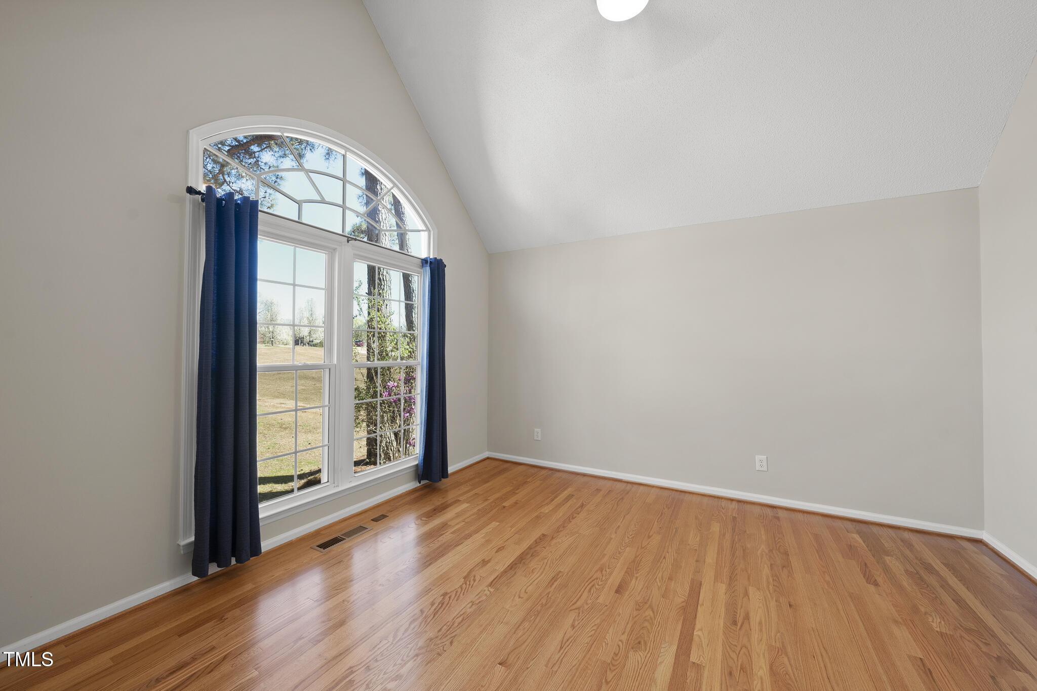 8063 Hogan Drive Wake Forest, NC 27587 - Photo 15 of 46 an empty room with wooden floor fan and windows