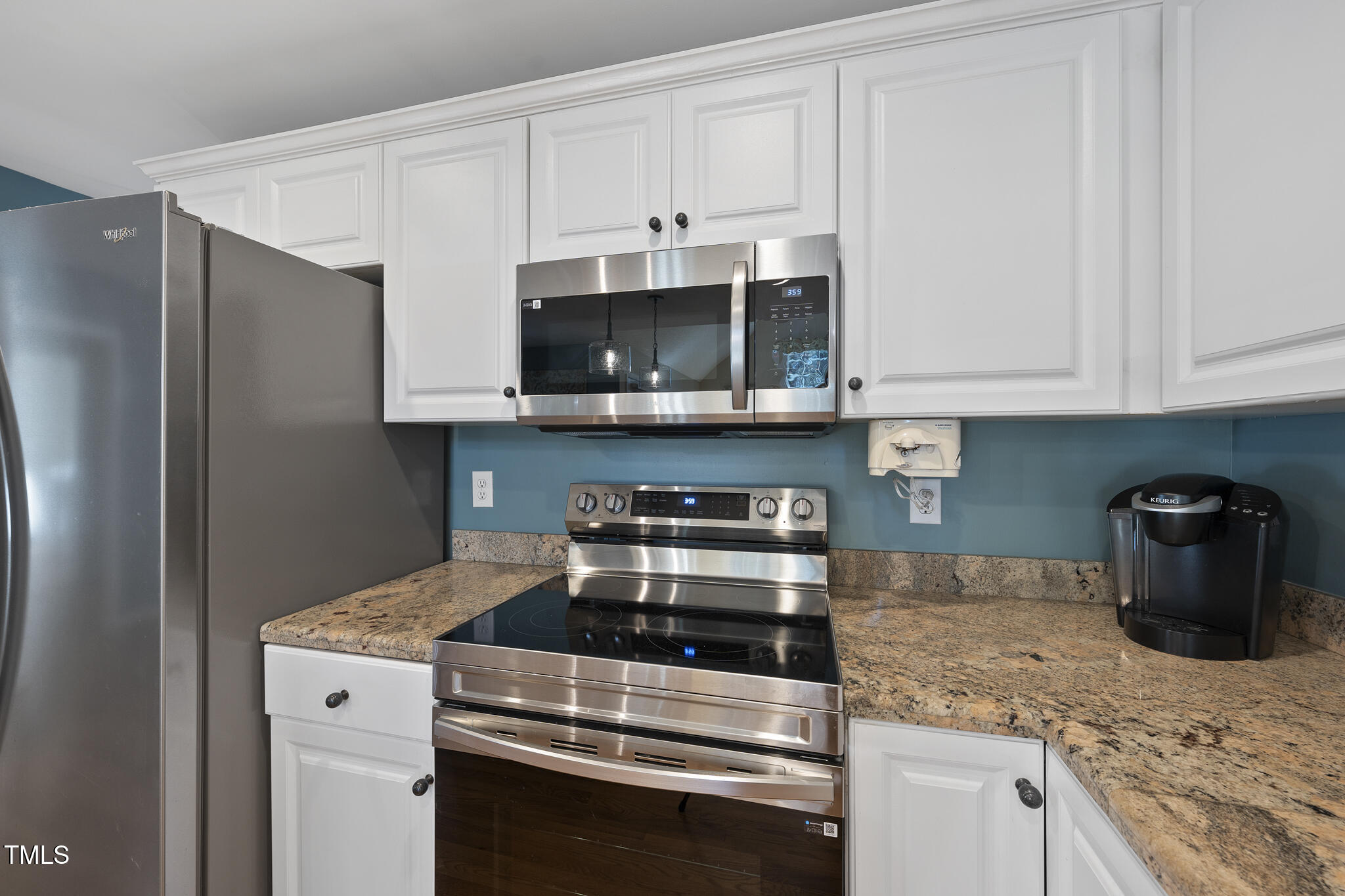 8063 Hogan Drive Wake Forest, NC 27587 - Photo 20 of 46 a kitchen with stainless steel appliances granite countertop a stove a microwave and a refrigerator