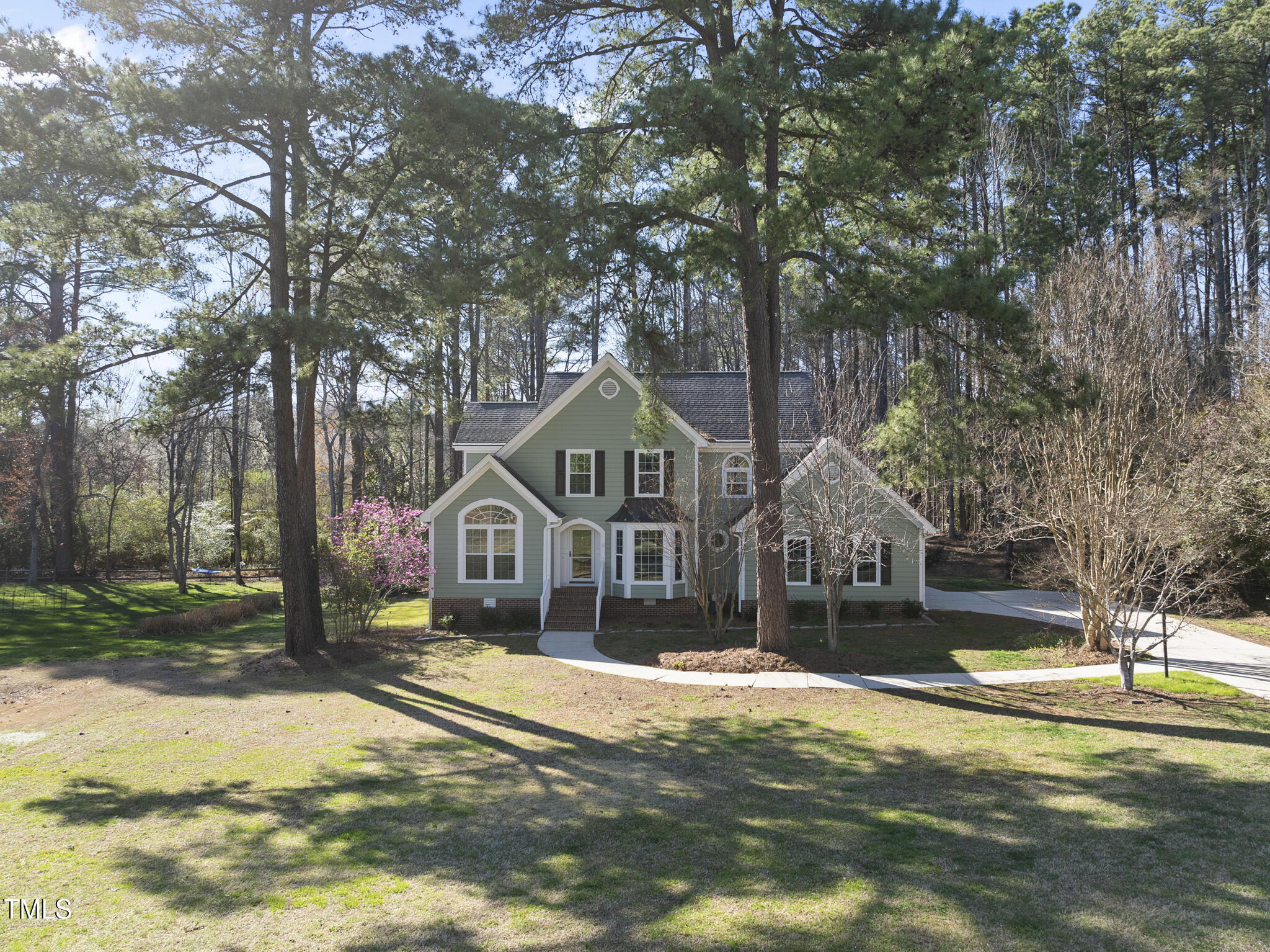 8063 Hogan Drive Wake Forest, NC 27587 - Photo 2 of 46 a front view of a house with a yard and large trees