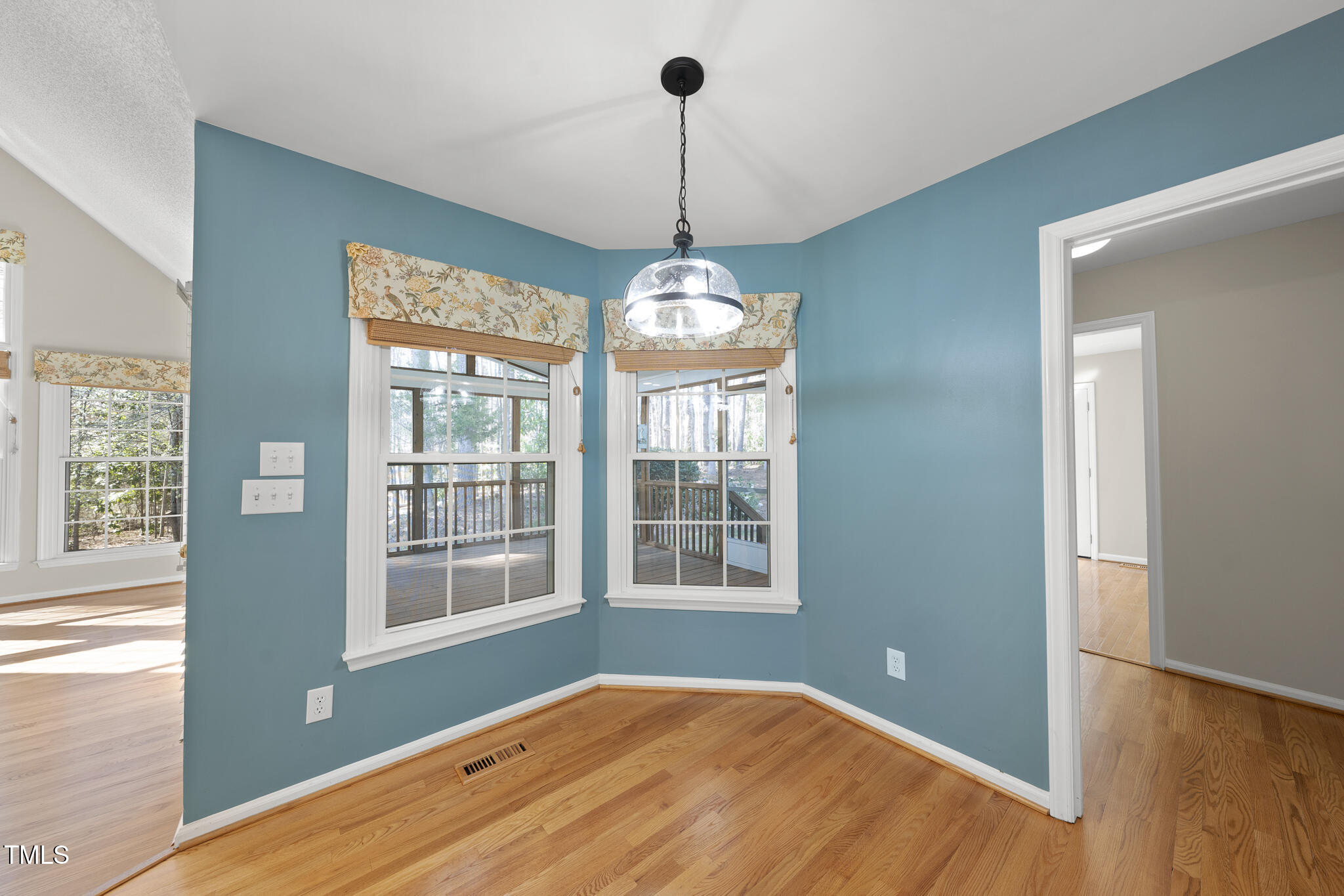 8063 Hogan Drive Wake Forest, NC 27587 - Photo 21 of 46 a view of an empty room with a window and wooden floor