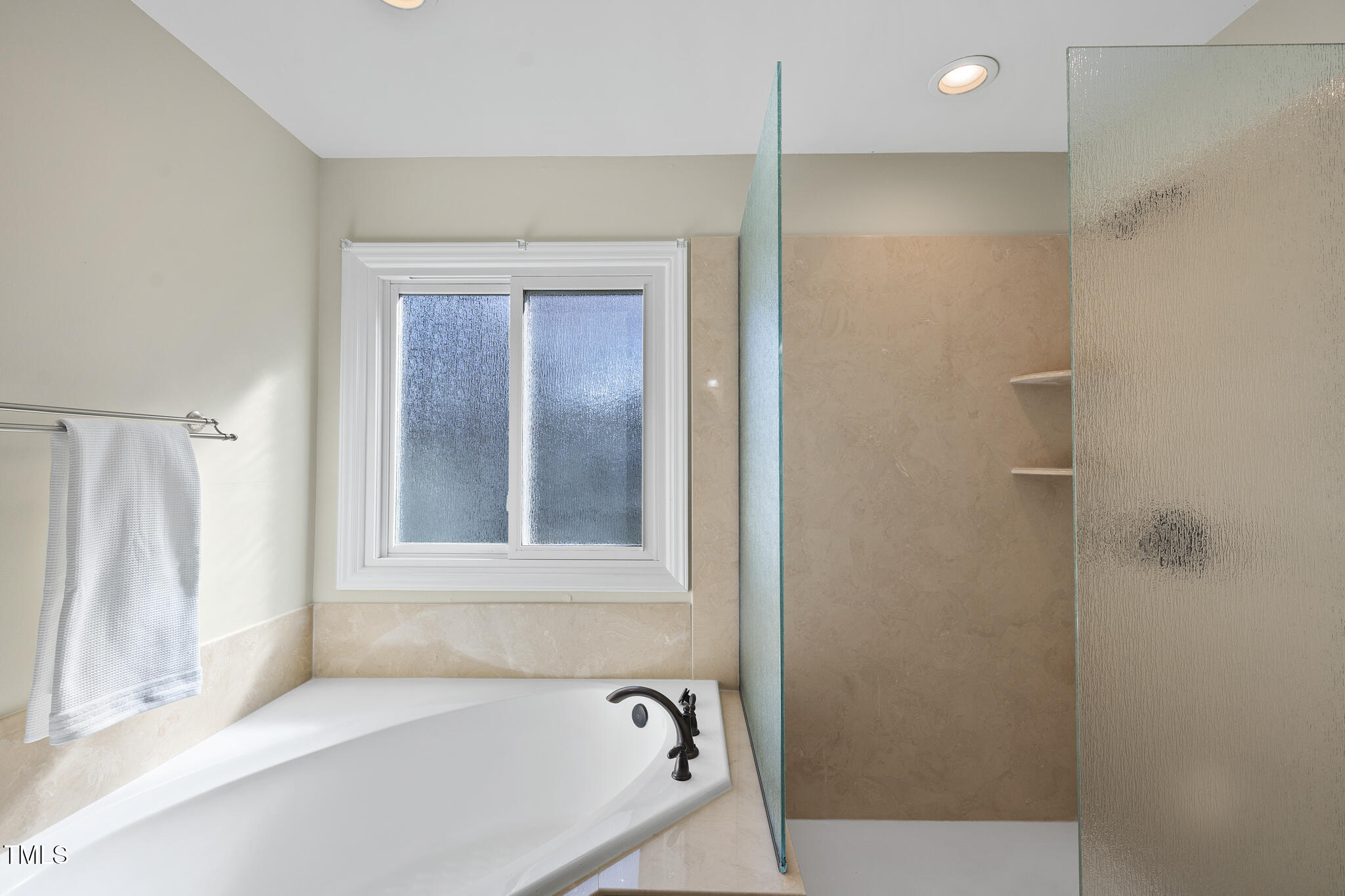 8063 Hogan Drive Wake Forest, NC 27587 - Photo 29 of 46 a bathroom with a bathtub and a shower