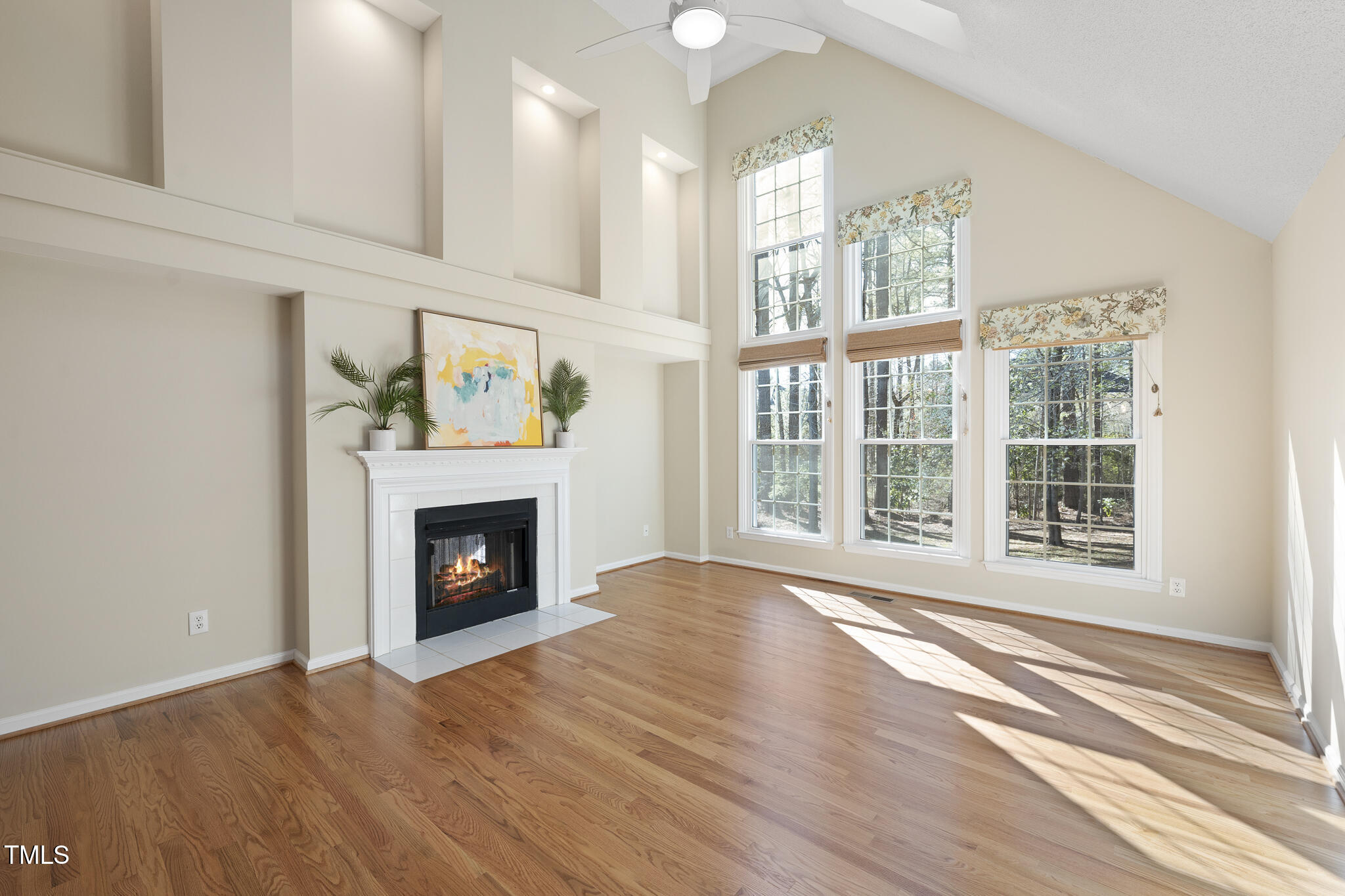 8063 Hogan Drive Wake Forest, NC 27587 - Photo 3 of 46 a view of an empty room with wooden floor and a window