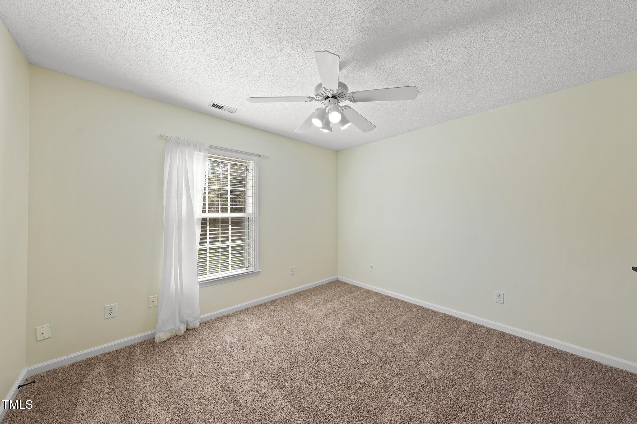 8063 Hogan Drive Wake Forest, NC 27587 - Photo 42 of 46 an empty room with windows and fan