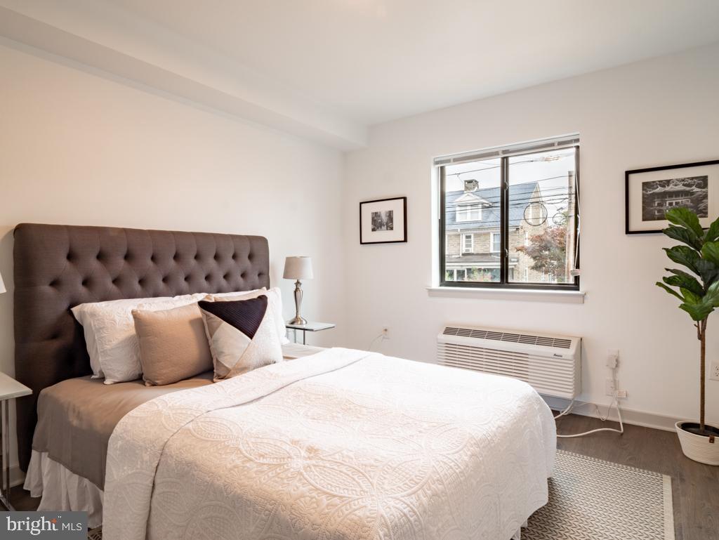 6808 Ridge Avenue, Unit 309 Philadelphia, PA 19128 - Photo 4 of 7 a bedroom with a large bed and a window