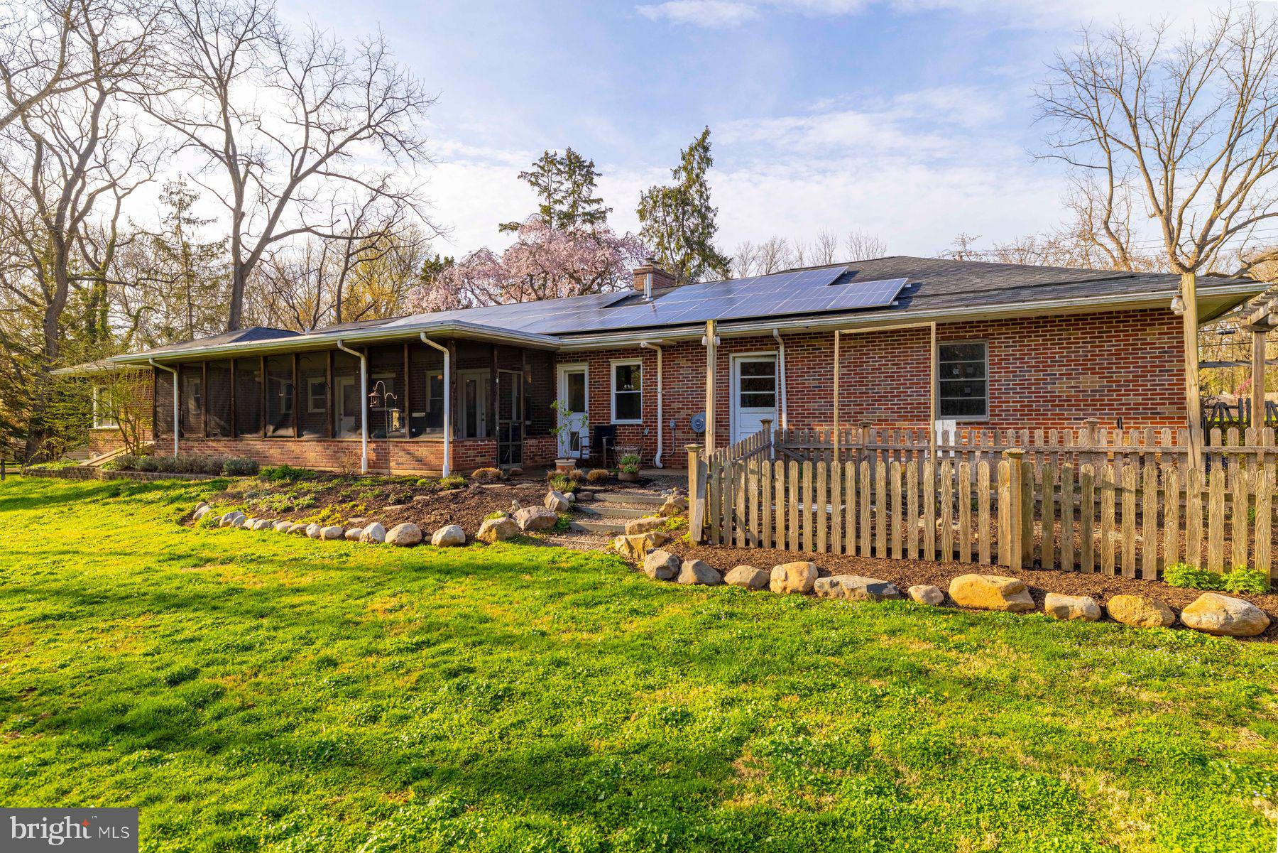 6254 West Valley Green Road Flourtown, PA 19031 - Photo 19 of 20 Charming brick home with lush greenery.