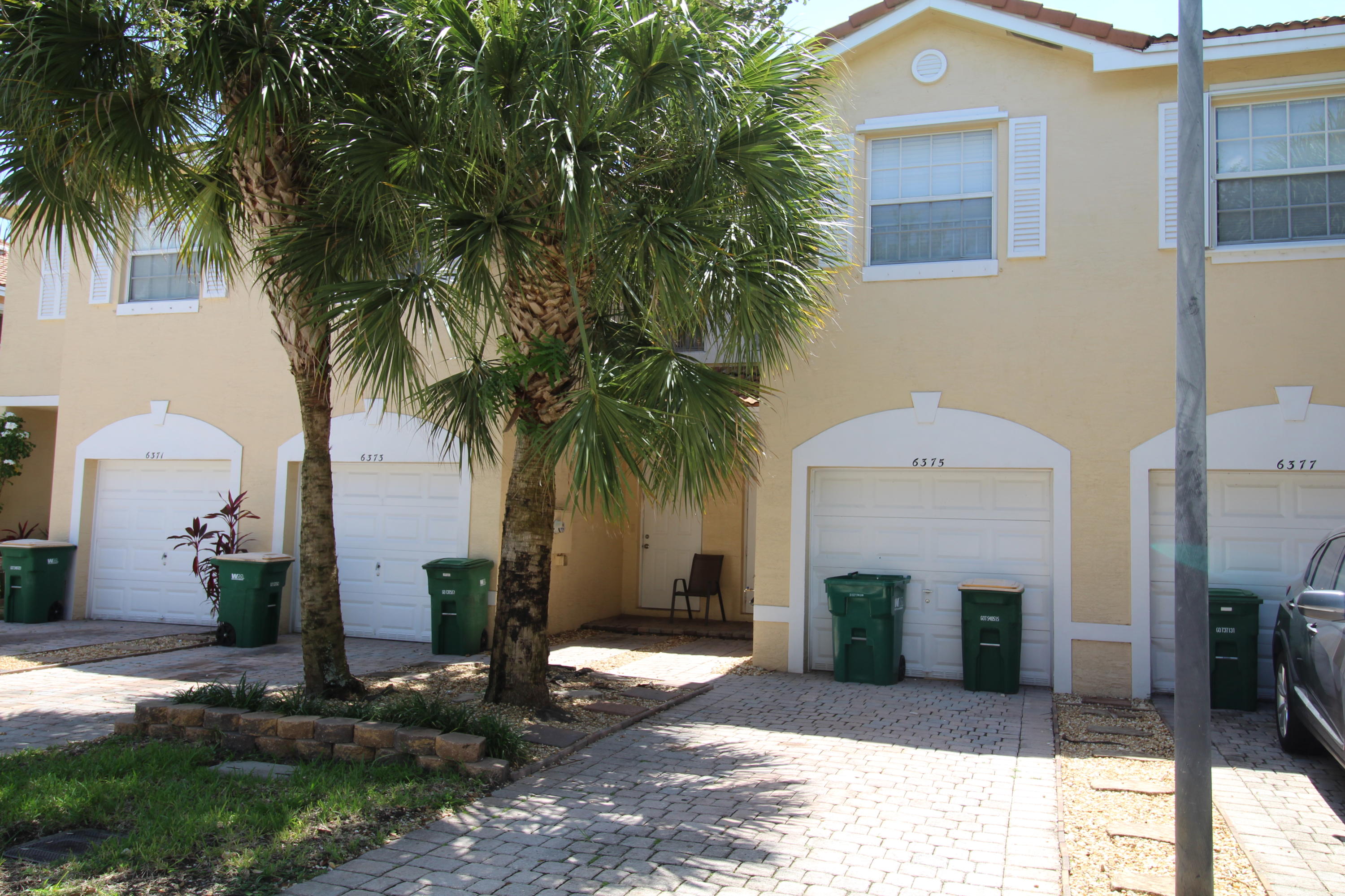 6375 Landings Way, Unit 6375 Tamarac, FL 33321 - Photo 1 of 14 a front view of a house with garden