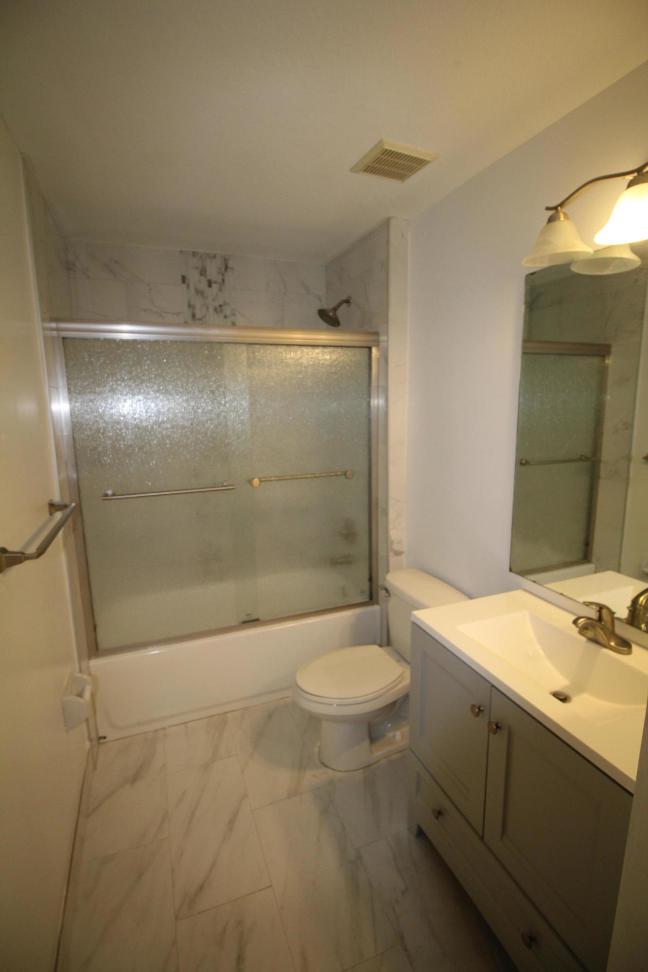 6375 Landings Way, Unit 6375 Tamarac, FL 33321 - Photo 12 of 14 a bathroom with a granite countertop sink toilet and shower