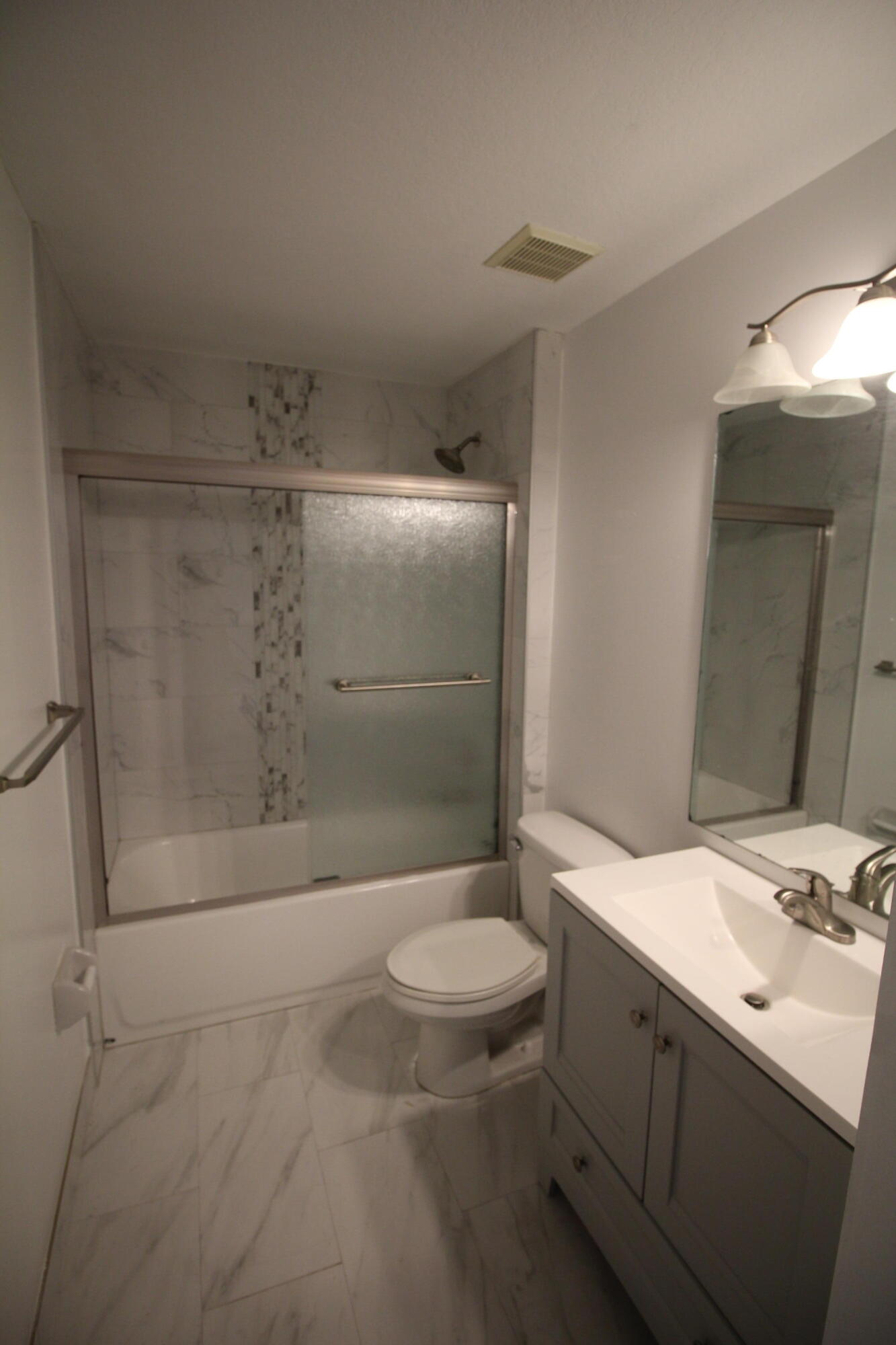 6375 Landings Way, Unit 6375 Tamarac, FL 33321 - Photo 13 of 14 a bathroom with a sink a toilet and shower