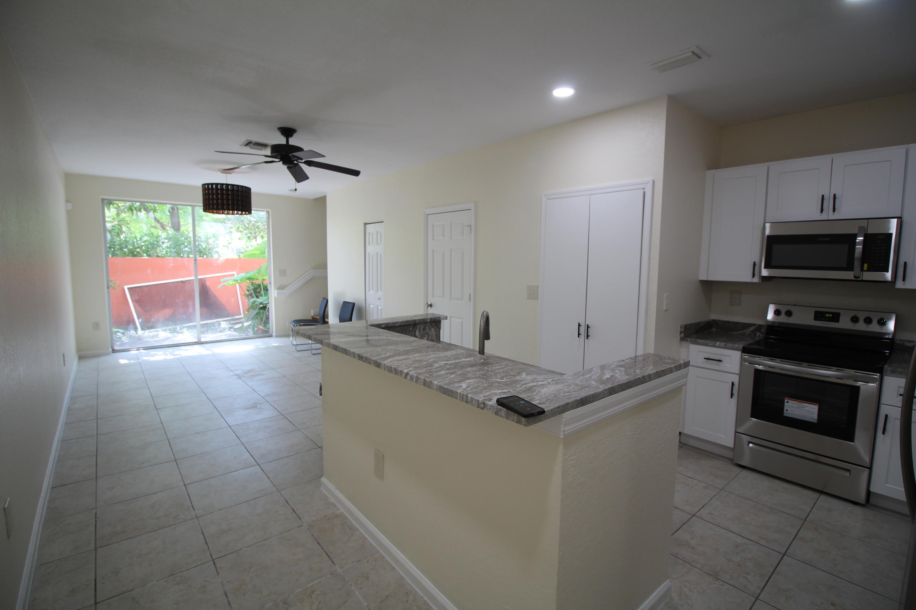 6375 Landings Way, Unit 6375 Tamarac, FL 33321 - Photo 4 of 14 a kitchen with stainless steel appliances granite countertop a sink and a stove