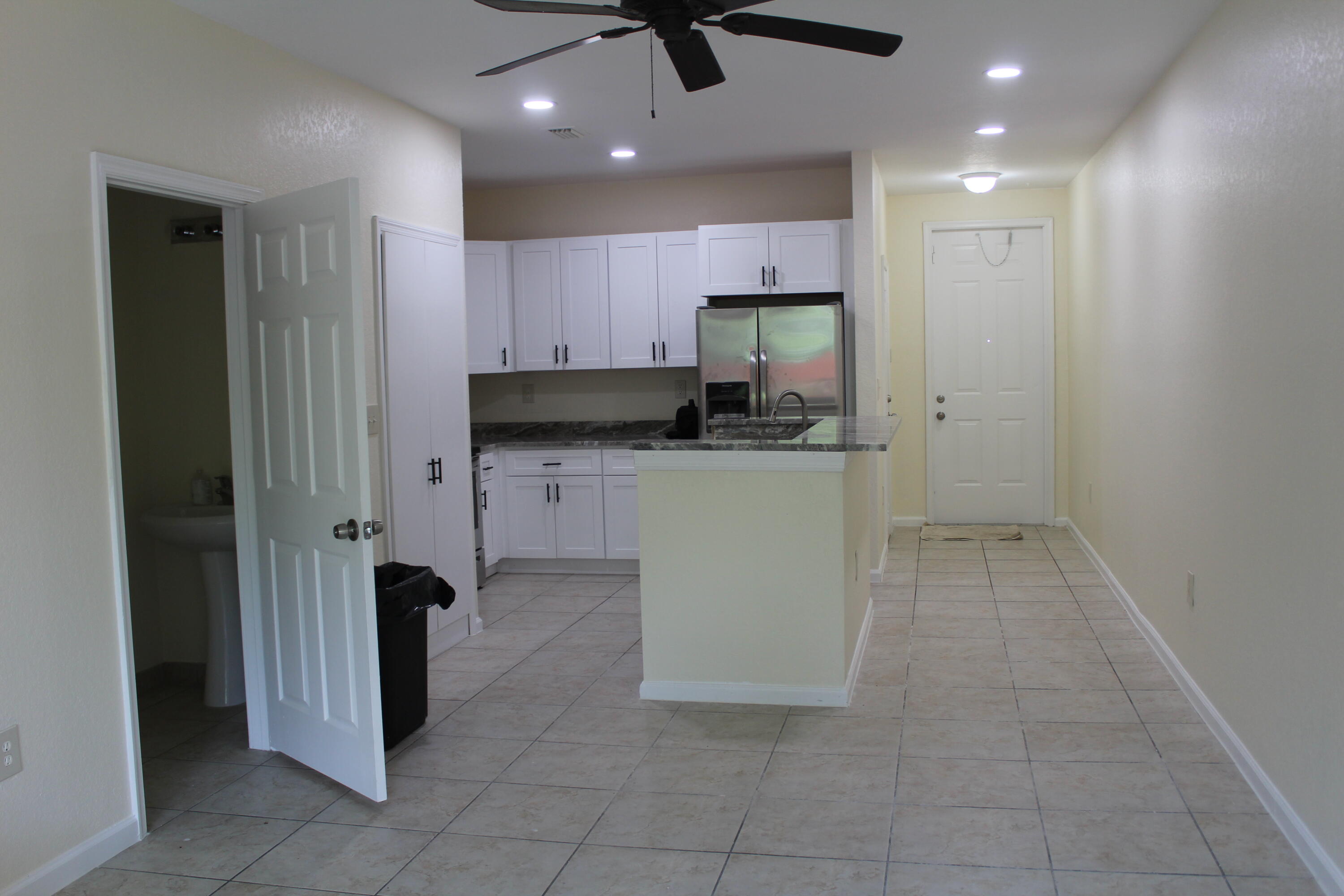 6375 Landings Way, Unit 6375 Tamarac, FL 33321 - Photo 5 of 14 a kitchen with a sink a refrigerator and cabinets