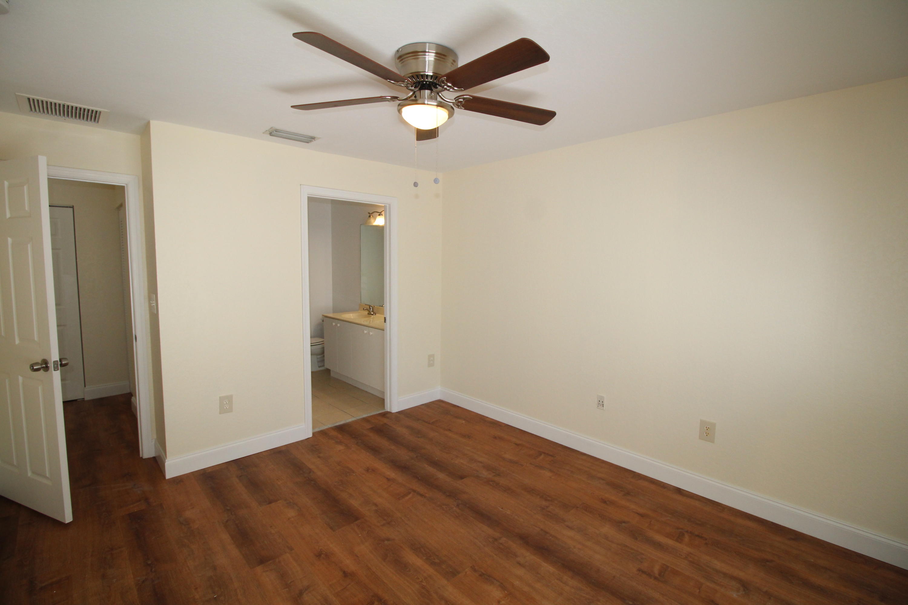 6375 Landings Way, Unit 6375 Tamarac, FL 33321 - Photo 8 of 14 an empty room with wooden floor and ceiling fan