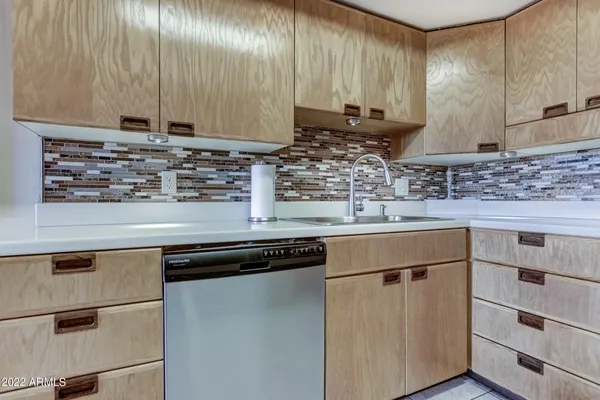 a kitchen with granite countertop a sink a stove and cabinets
