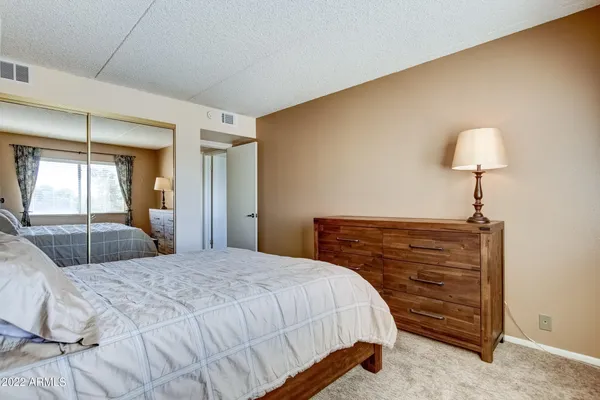 a bedroom with a bed and a lamp