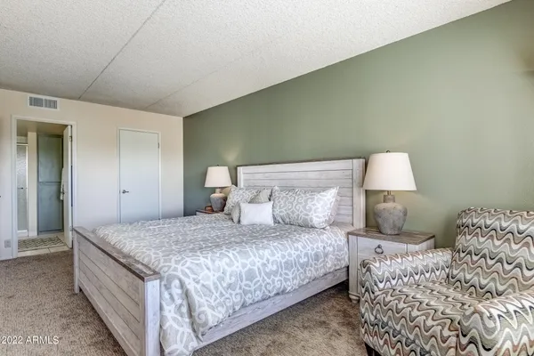 a bedroom with a bed and a lamp