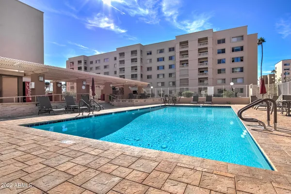 a view of a swimming pool and lounge chairs
