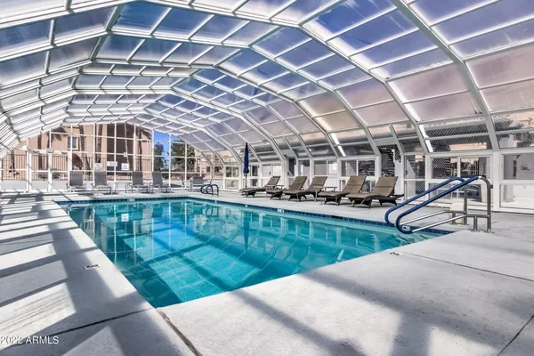 a view of a swimming pool with a outdoor seating