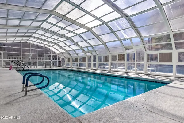 a view of a swimming pool with a outdoor seating