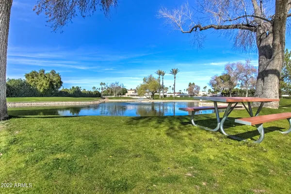 a view of a chair and table on the grass