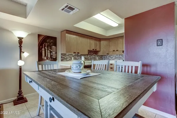 a kitchen with stainless steel appliances granite countertop a sink a table and chairs