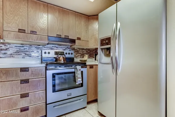 a kitchen with stainless steel appliances granite countertop a stove and a refrigerator