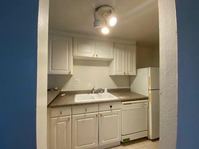 a kitchen with cabinets and appliances