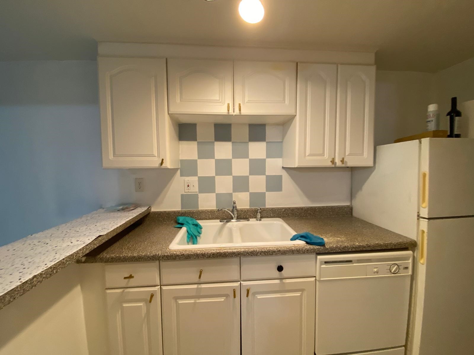 1909 Colquitt Street, Unit 3 Houston, TX 77098 - Photo 7 of 16 a kitchen with a sink a refrigerator and cabinets