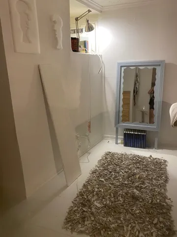 a bedroom with a bed and a large mirror