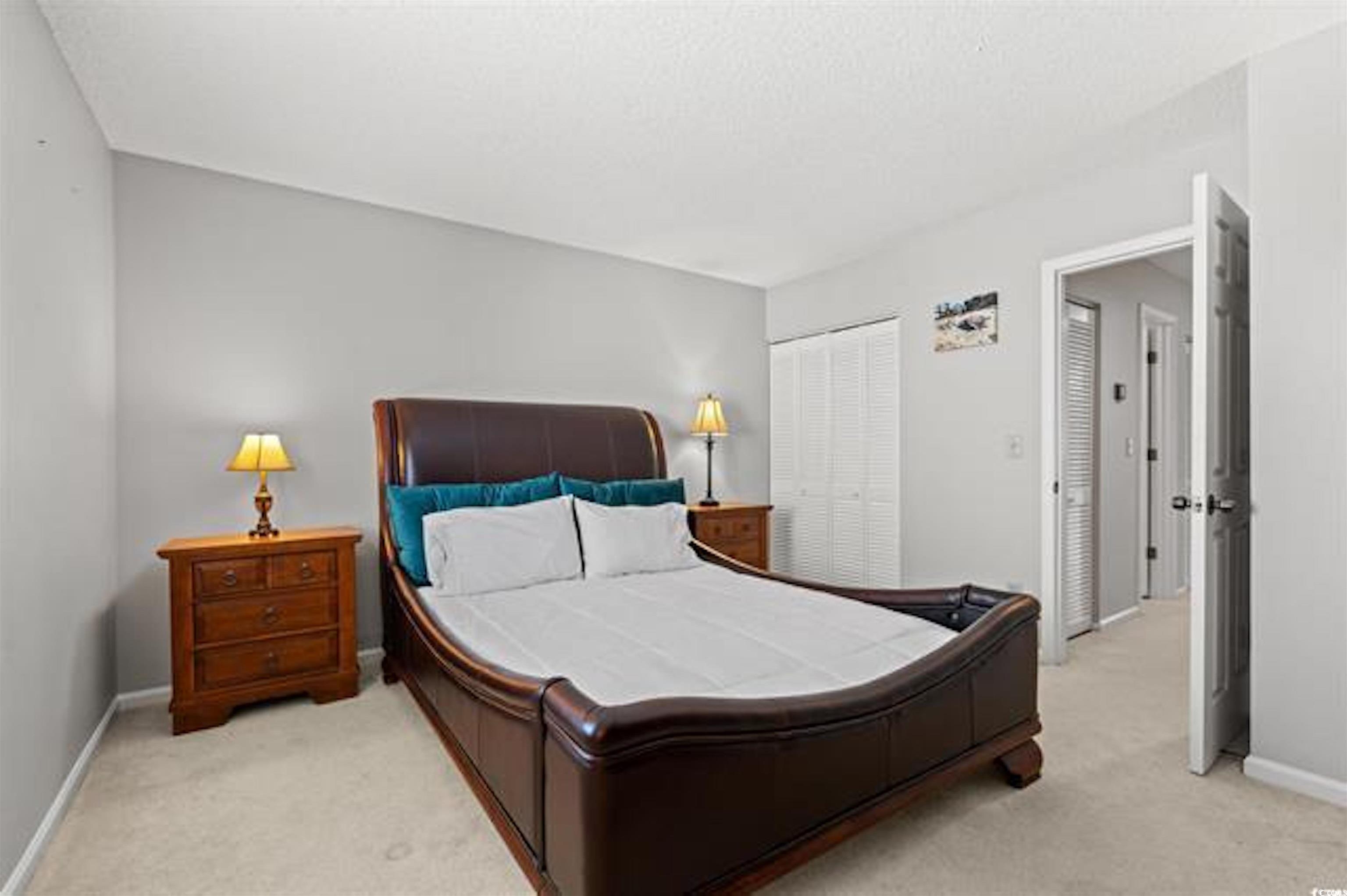 1100 Possum Trot Road, Unit B206 North Myrtle Beach, SC 29582 - Photo 14 of 16 Bedroom with baseboards, a closet, and light color