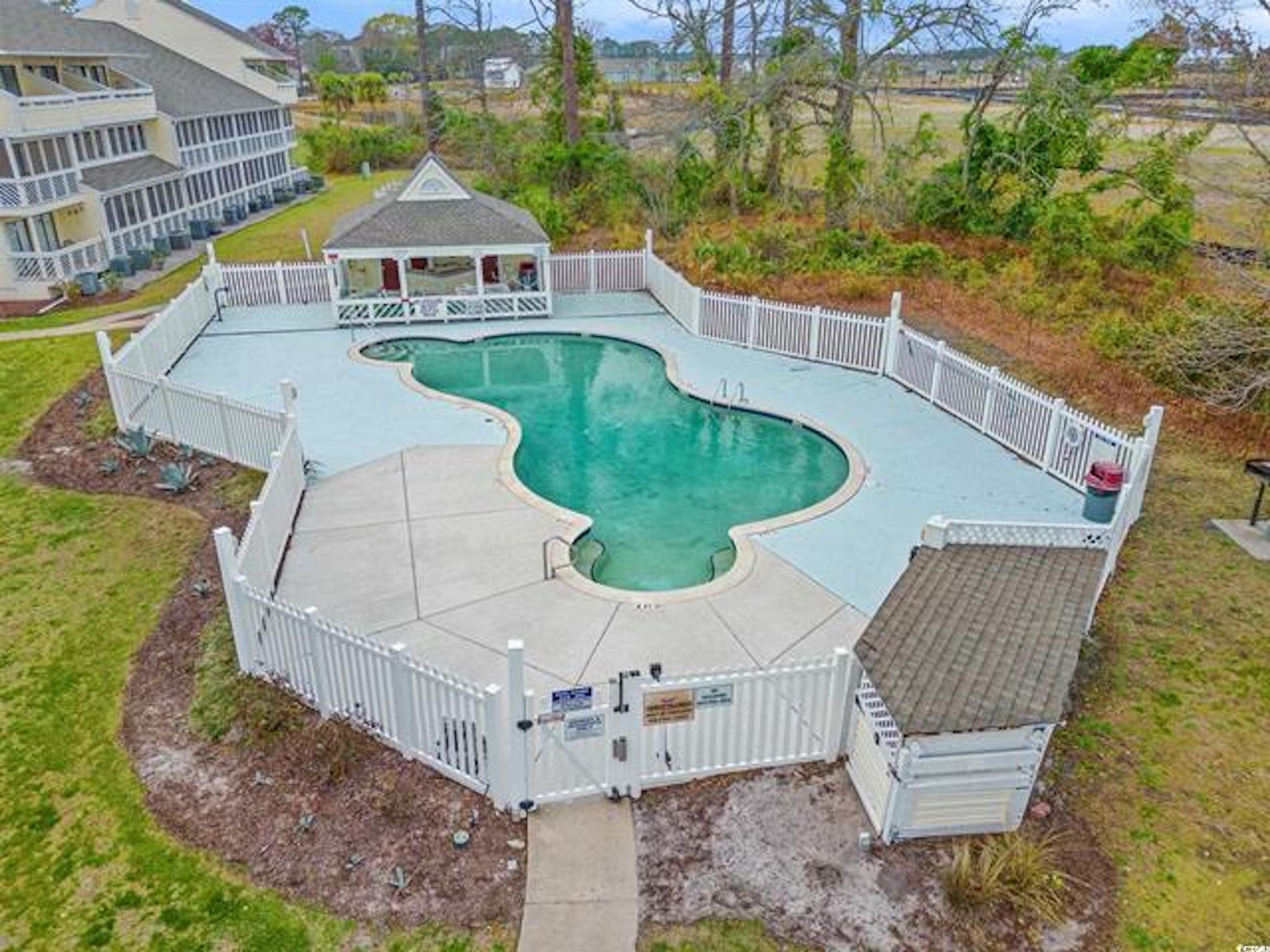 1100 Possum Trot Road, Unit B206 North Myrtle Beach, SC 29582 - Photo 2 of 16 View of swimming pool featuring a gate, a patio ar