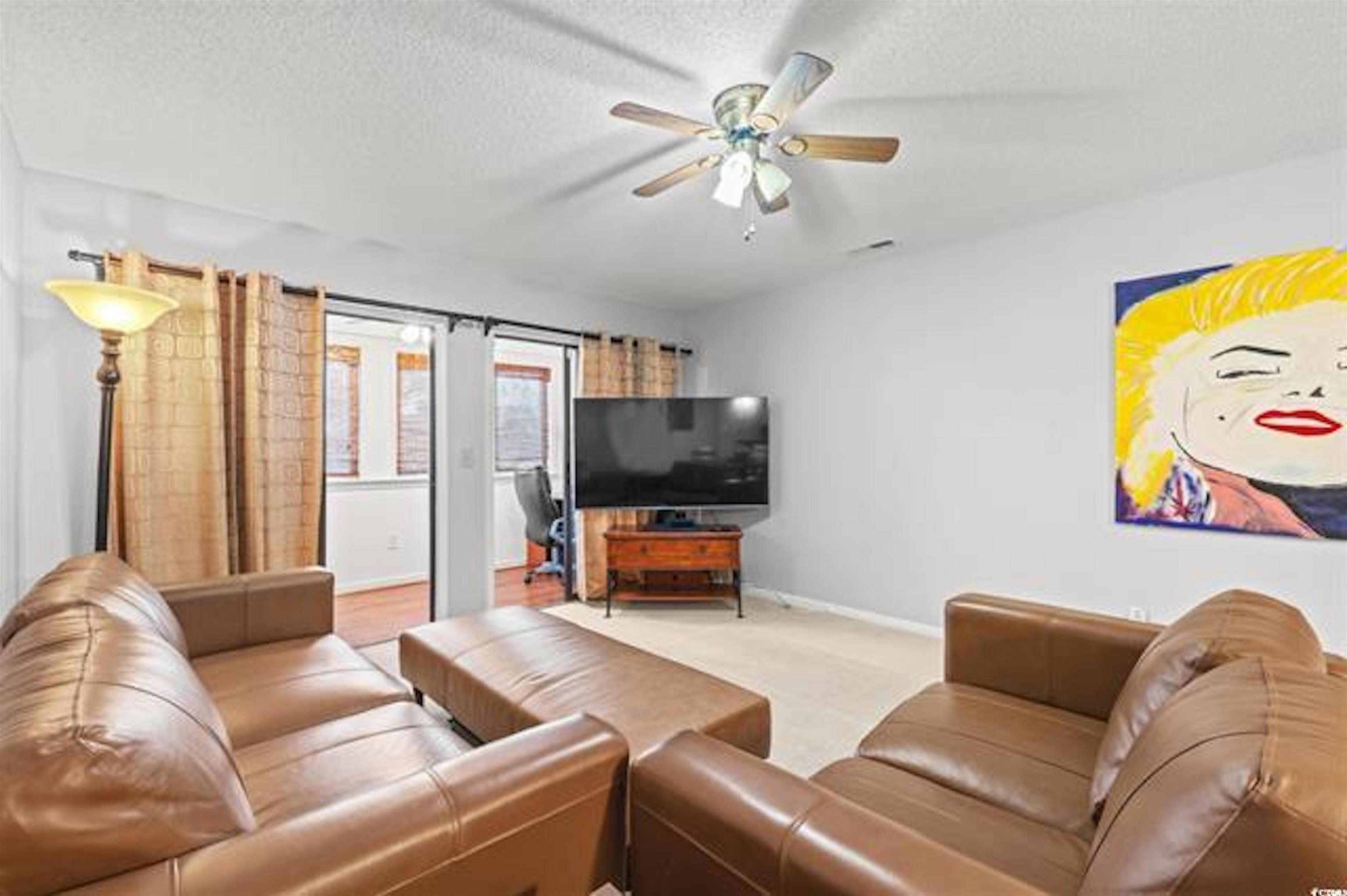1100 Possum Trot Road, Unit B206 North Myrtle Beach, SC 29582 - Photo 4 of 16 Living area with baseboards, a textured ceiling, v