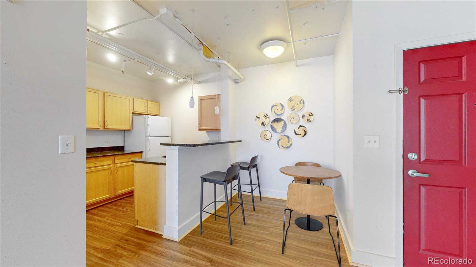 444 17th Street, Unit 301 Denver, CO 80202 - Photo 3 of 21 a kitchen with a refrigerator and a stove top oven