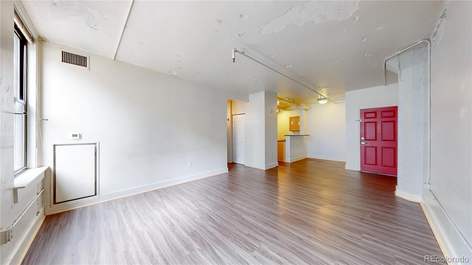 444 17th Street, Unit 301 Denver, CO 80202 - Photo 6 of 21 a view of an empty room with window and wooden floor