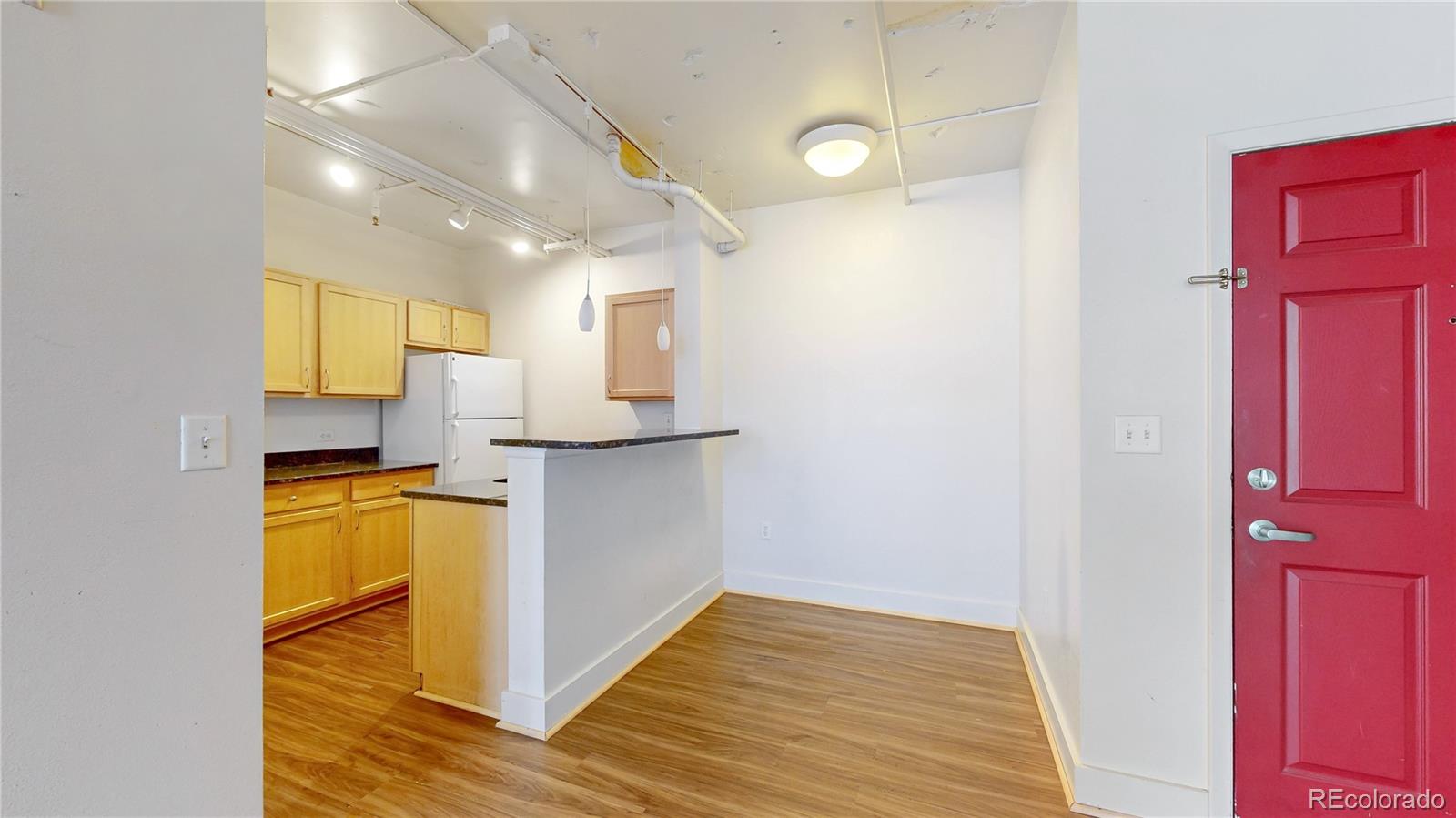 444 17th Street, Unit 301 Denver, CO 80202 - Photo 8 of 21 a view of a kitchen with wooden floor and a sink