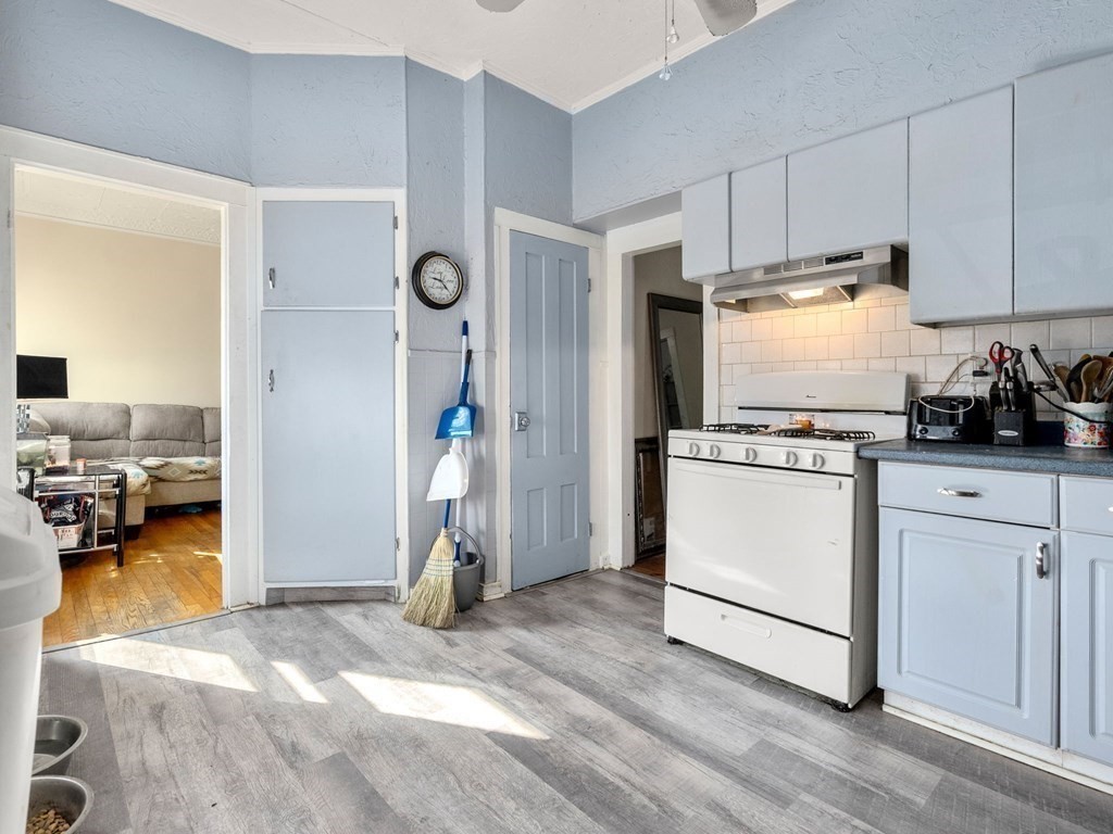173 School Street Webster, MA 01570 - Photo 17 of 26 a kitchen with a refrigerator and white cabinets