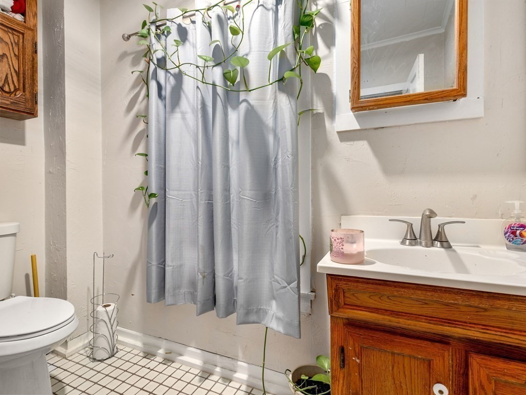 173 School Street Webster, MA 01570 - Photo 20 of 26 a bathroom with a sink toilet and shower