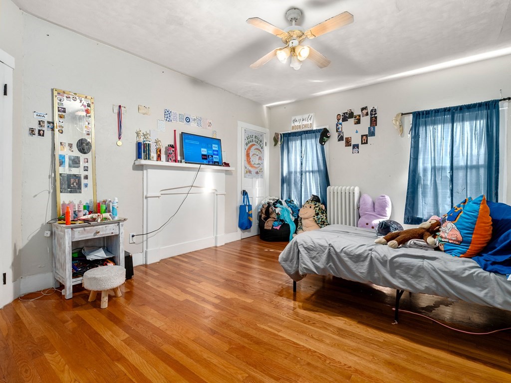 173 School Street Webster, MA 01570 - Photo 23 of 26 a bedroom with a bed and a chandelier