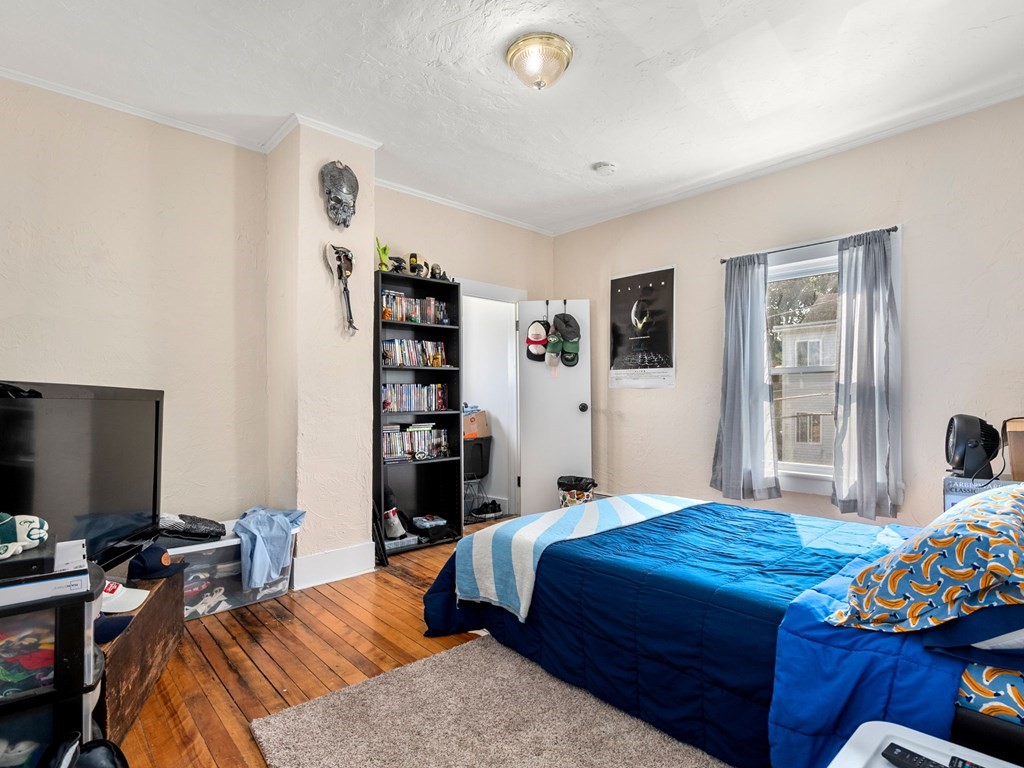 173 School Street Webster, MA 01570 - Photo 24 of 26 a bedroom with a bed and a flat screen tv