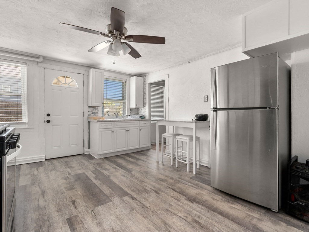 173 School Street Webster, MA 01570 - Photo 5 of 26 a kitchen with cabinets a refrigerator and a sink