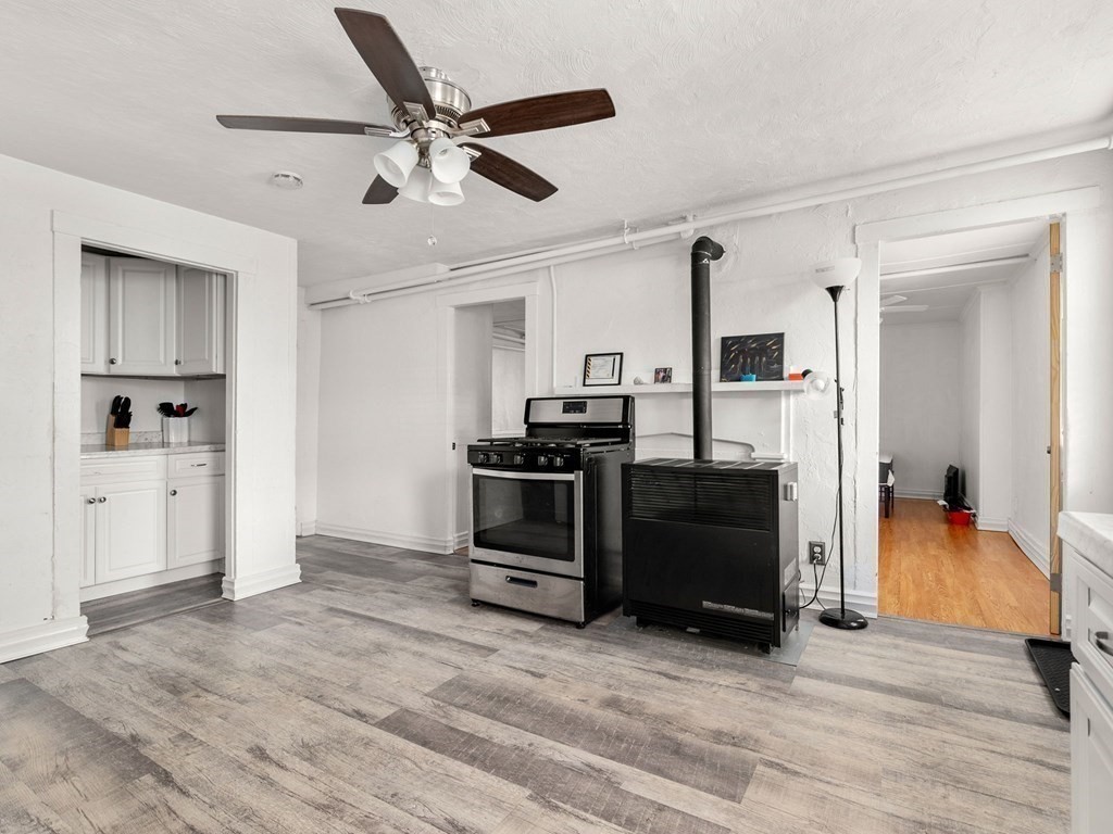 173 School Street Webster, MA 01570 - Photo 6 of 26 a kitchen with a refrigerator and a stove top oven