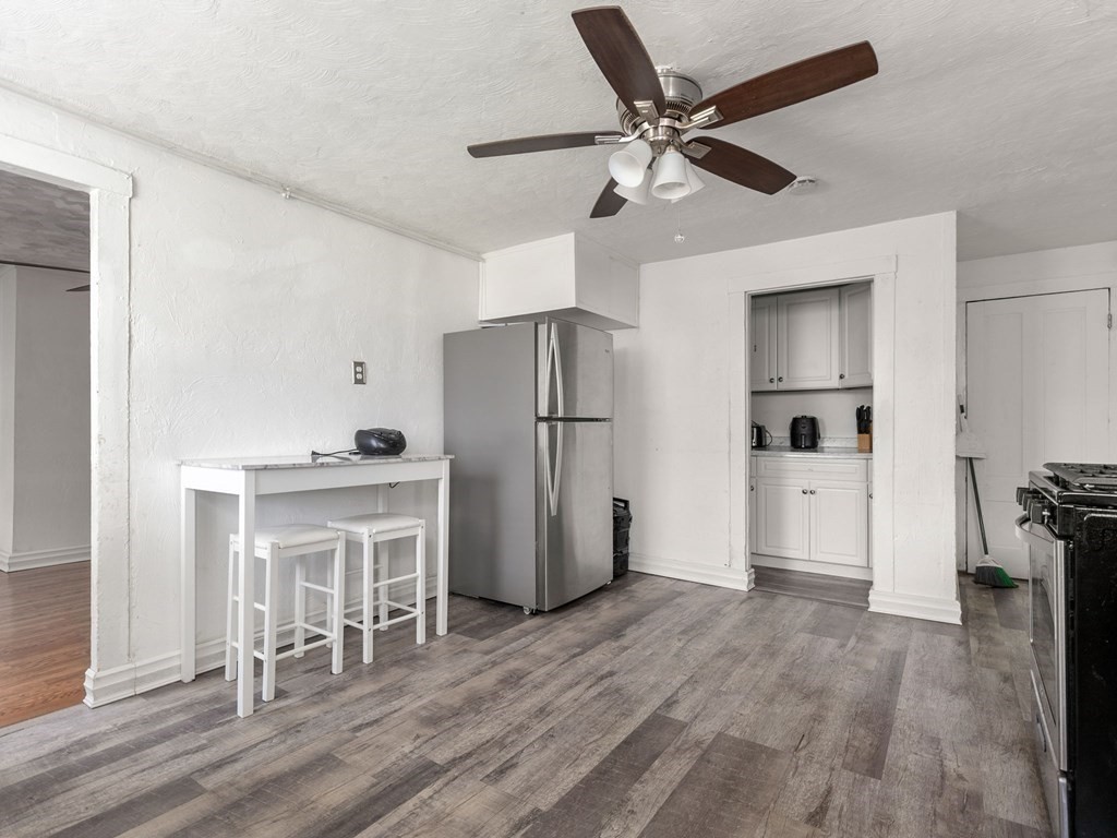 173 School Street Webster, MA 01570 - Photo 7 of 26 a kitchen with a refrigerator a microwave and cabinets