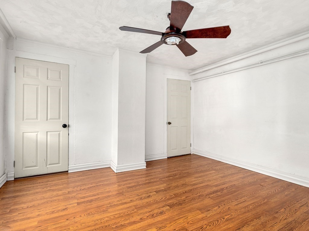 173 School Street Webster, MA 01570 - Photo 8 of 26 a view of room with wooden floor and fan