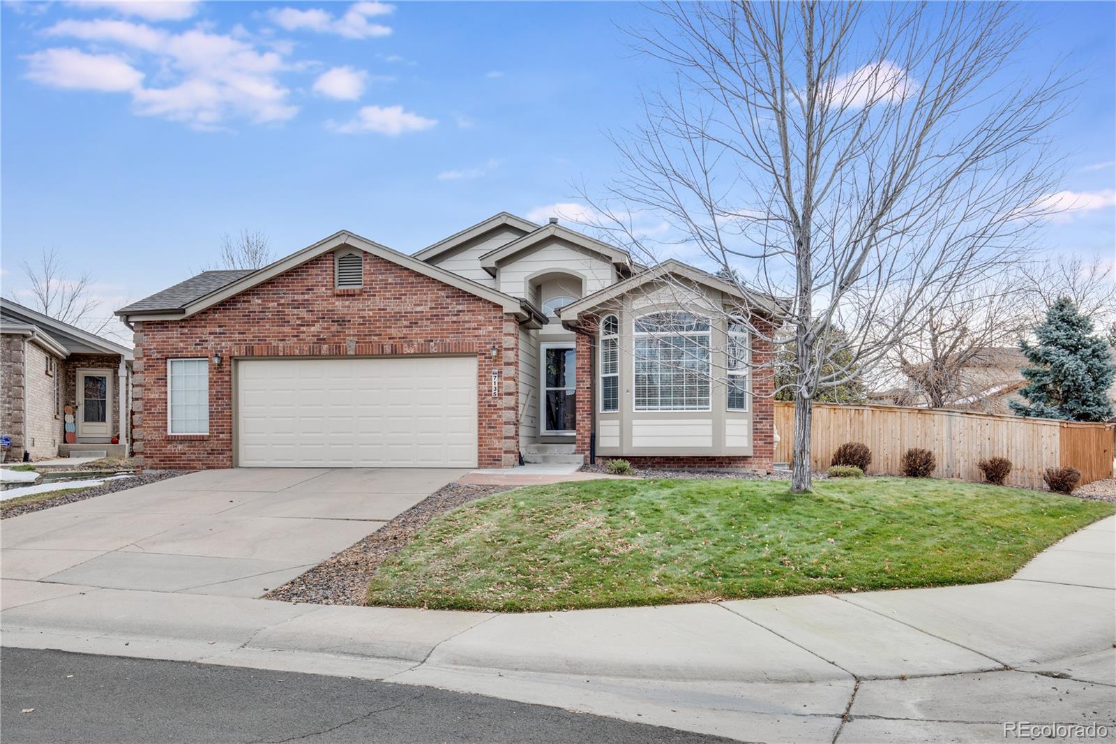 7135 Leopard Drive Lone Tree, CO 80124 - Photo 1 of 47 a front view of a house with a yard and garage